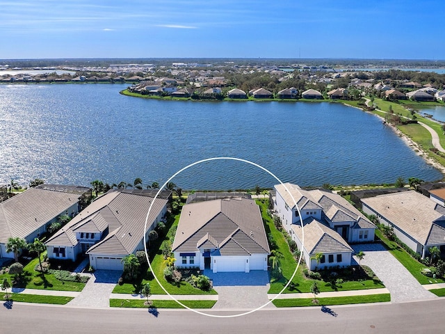 birds eye view of property with a water view