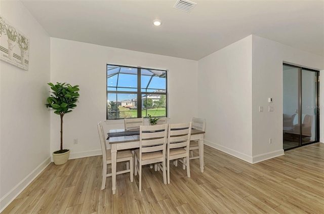 dining room featuring recessed lighting, baseboards, visible vents, and light wood finished floors