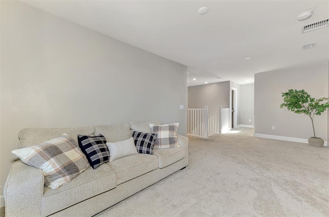 living area with recessed lighting, carpet, visible vents, and baseboards