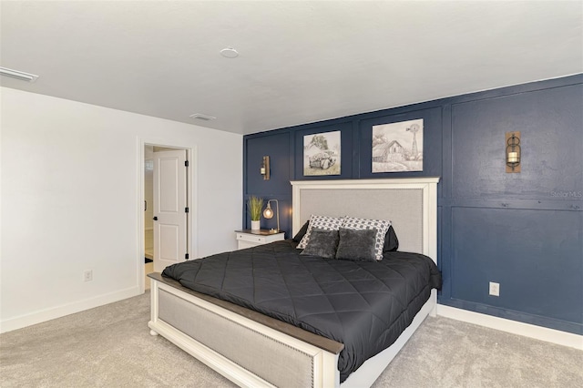 carpeted bedroom featuring visible vents and baseboards