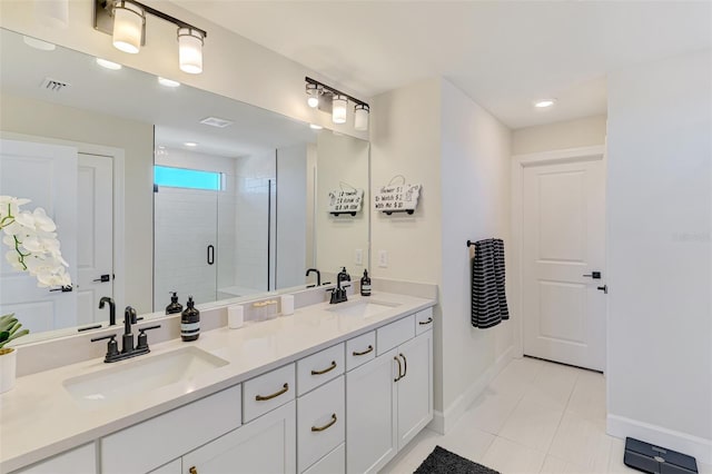 bathroom featuring double vanity, a stall shower, baseboards, and a sink