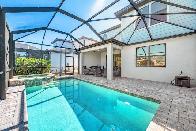 view of pool with a pool with connected hot tub, glass enclosure, and a patio