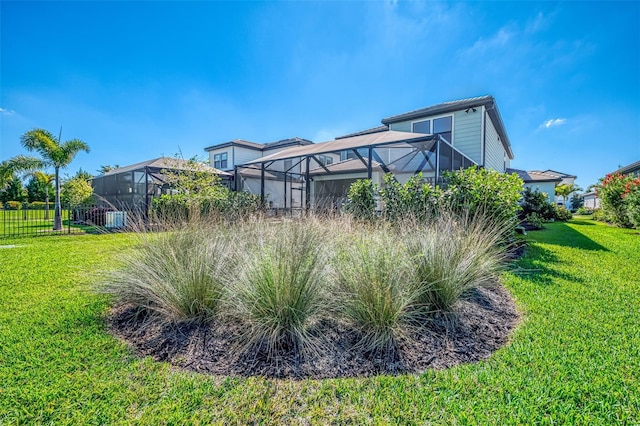 view of yard featuring a lanai and fence