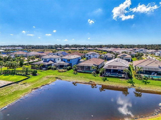 drone / aerial view with a water view and a residential view