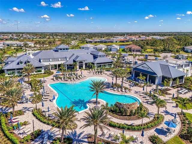 community pool with a patio area and a residential view