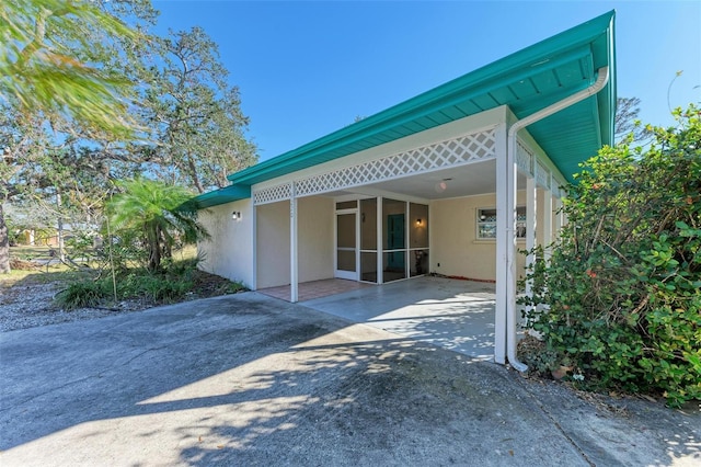 view of property exterior with a patio area