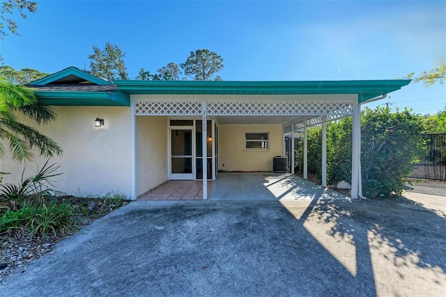 exterior space with central air condition unit and a carport