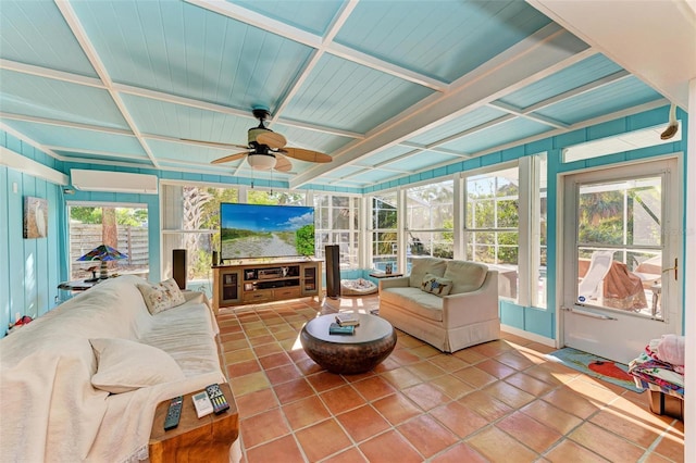 sunroom / solarium with a wall mounted air conditioner, plenty of natural light, ceiling fan, and coffered ceiling