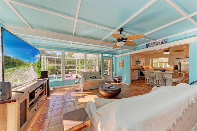 tiled living room featuring ceiling fan