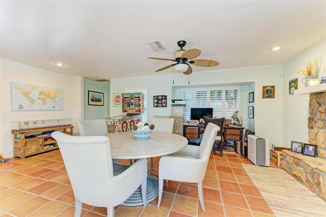 dining room with tile patterned floors, ceiling fan, and ornamental molding