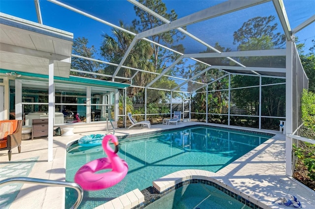 view of swimming pool with glass enclosure and a patio