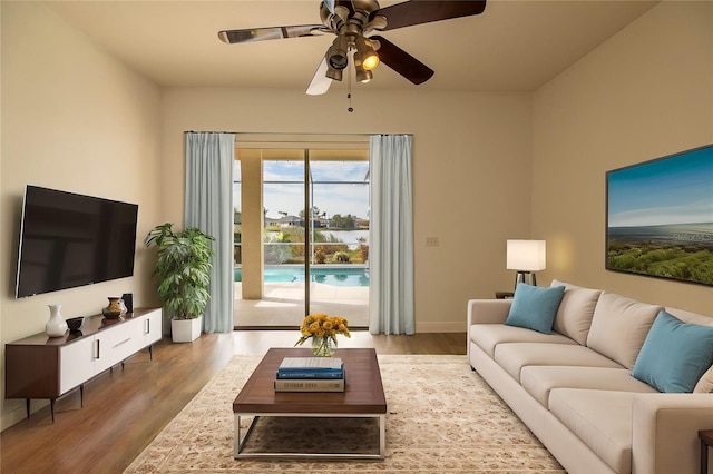 living room featuring hardwood / wood-style flooring and ceiling fan