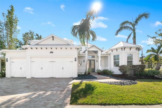 view of front of home with a front yard and a garage