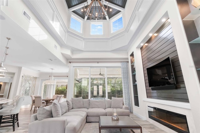 living room with a high ceiling and ceiling fan