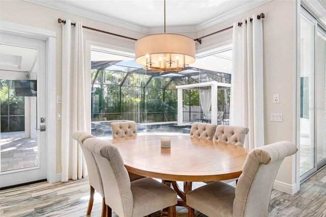 dining space featuring crown molding and a chandelier