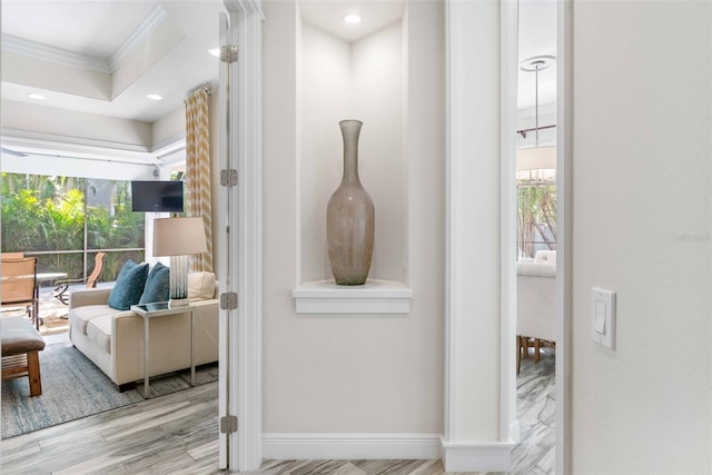 interior space with light wood-type flooring and ornamental molding