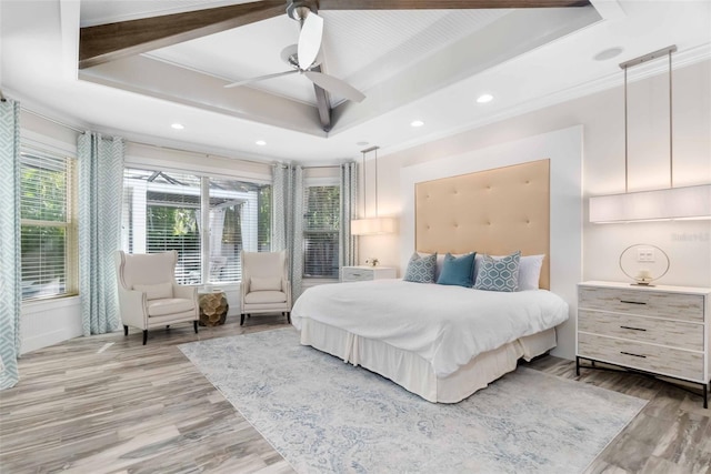 bedroom featuring ceiling fan, ornamental molding, and light wood-type flooring