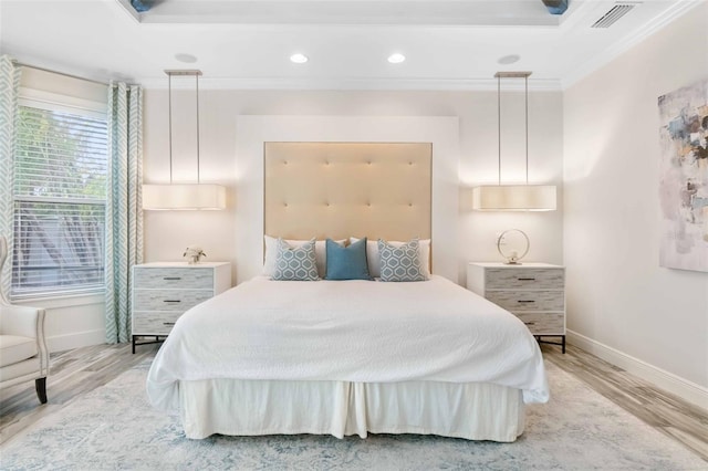 bedroom featuring light hardwood / wood-style floors and crown molding