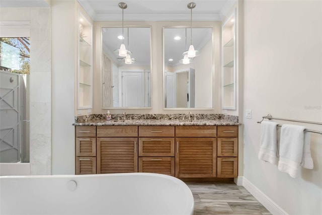 bathroom featuring vanity, built in features, a bathing tub, and crown molding