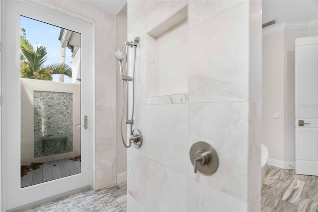 bathroom with ornamental molding and walk in shower