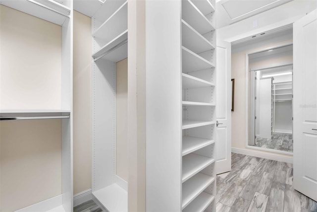 walk in closet featuring light hardwood / wood-style floors