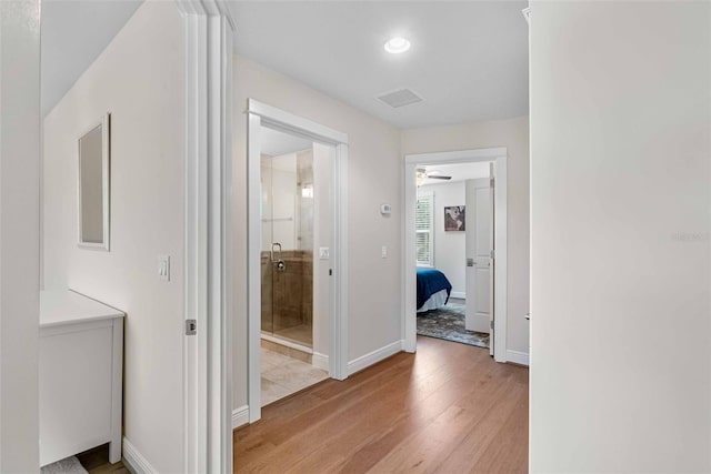 corridor featuring light hardwood / wood-style floors