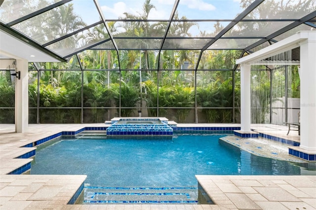 view of pool with an in ground hot tub, a patio area, and a lanai