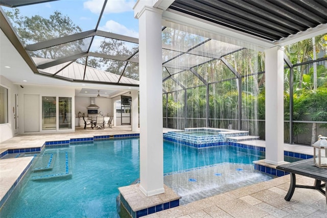 view of pool with ceiling fan, a lanai, pool water feature, a patio area, and an in ground hot tub