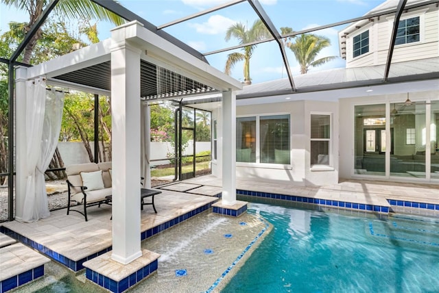 view of swimming pool with glass enclosure, ceiling fan, and a patio area