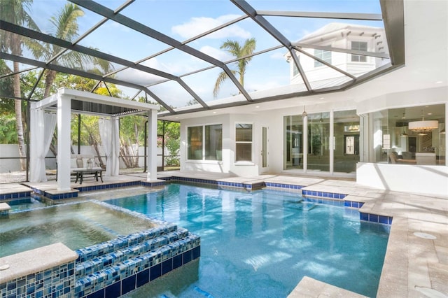 view of pool with a patio area, a lanai, and an in ground hot tub