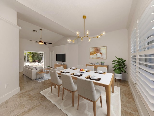 dining space featuring vaulted ceiling and ceiling fan with notable chandelier