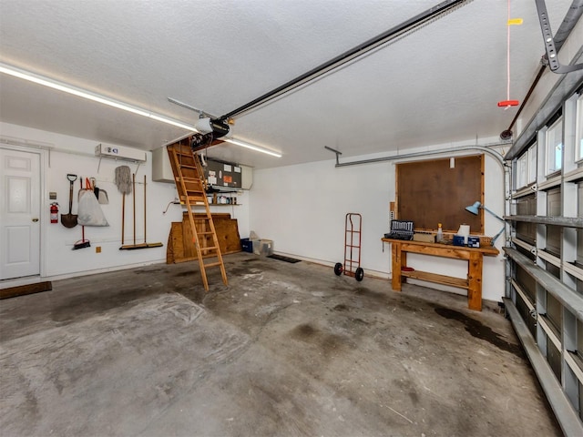 garage featuring a wall unit AC and a workshop area