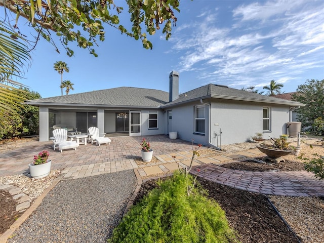 back of property with a patio