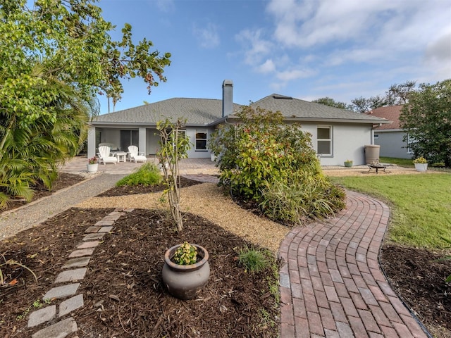 rear view of property featuring a patio area