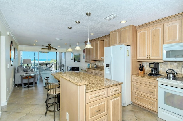 kitchen with pendant lighting, a center island, light brown cabinets, white appliances, and ceiling fan