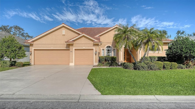 view of front of home featuring a front yard and a garage