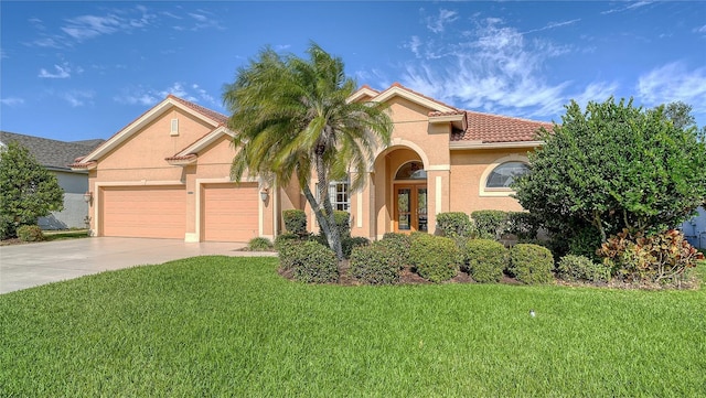 view of front of house featuring a garage and a front lawn