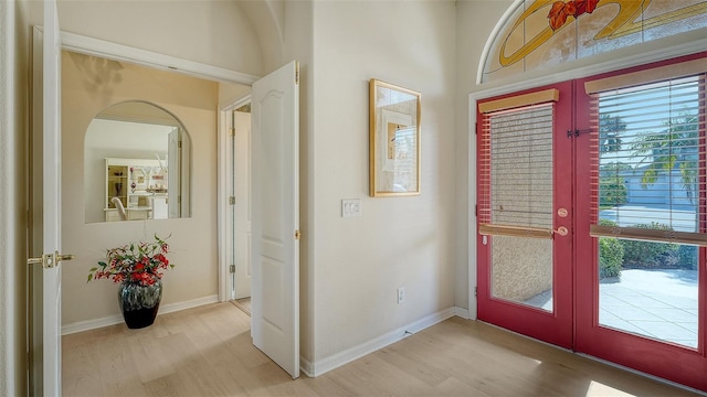 entryway with french doors and light hardwood / wood-style flooring