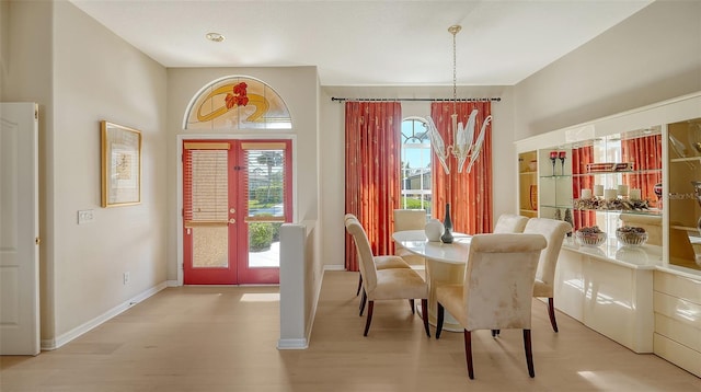 dining space featuring french doors and light hardwood / wood-style flooring