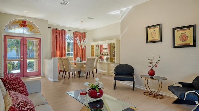 living room featuring light wood-type flooring and french doors