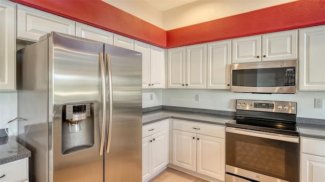 kitchen featuring stainless steel appliances and white cabinets