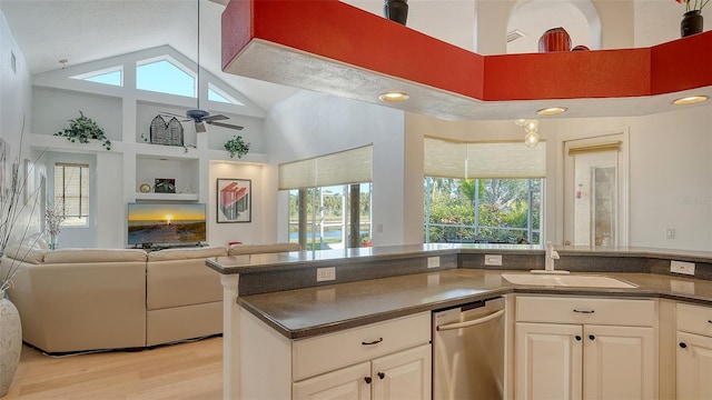 kitchen featuring sink, white cabinetry, dishwasher, ceiling fan, and a healthy amount of sunlight