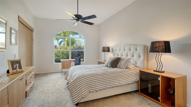 bedroom with ceiling fan, light colored carpet, and lofted ceiling