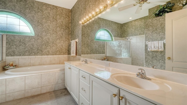 bathroom with ceiling fan, separate shower and tub, and vanity