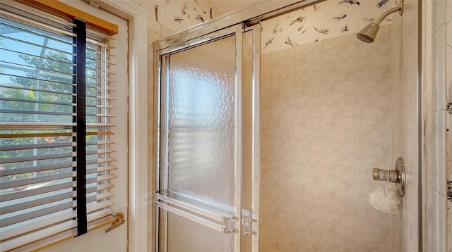 bathroom with a shower with door