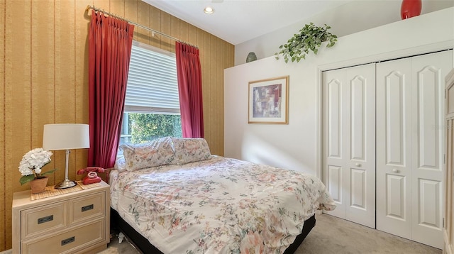 bedroom featuring light colored carpet and a closet