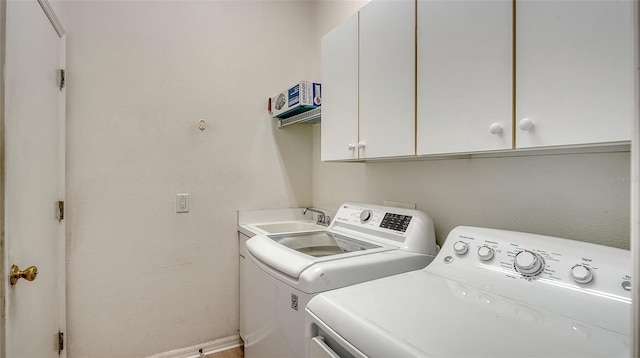 laundry room featuring sink, cabinets, and washing machine and dryer