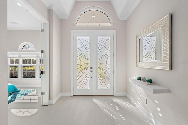 entryway featuring high vaulted ceiling and french doors