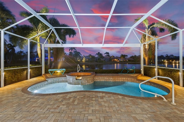 pool at dusk featuring a patio, a lanai, an in ground hot tub, and a water view