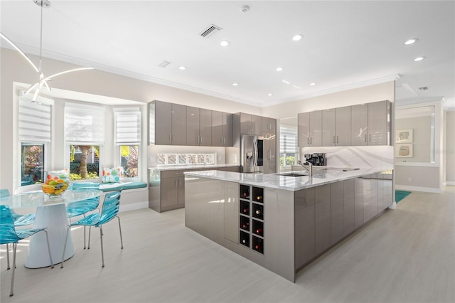 kitchen featuring gray cabinetry, pendant lighting, and tasteful backsplash